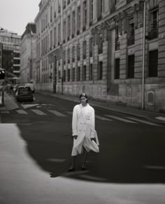 a woman standing in the middle of an empty street