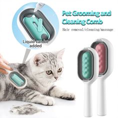 a cat laying next to two electric toothbrushes