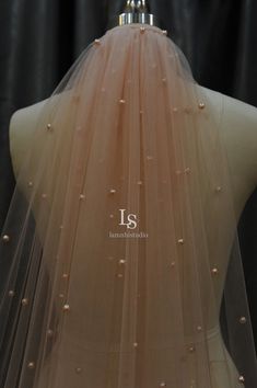 the back of a dress with pearls on it