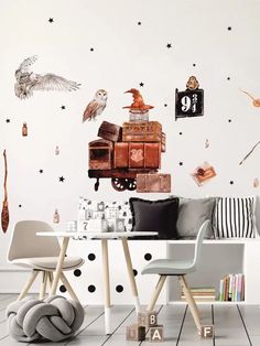 a room with a table, chair and wall decals