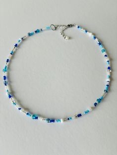 Summer Seed Bead Mixed Blue Necklace! Perfect for the beach, a picnic, boat ride or any sunny day! Get for yourself or a friend as a Summer birthday gift <3 ABOUT    ▢  Size: 15 inches goes up to 17 inches with chain extension. (Can be customized to a smaller or larger size just message me  ▢  Materials: Fishing Line for durability, stainless steel lobster clasp, 2mm / 3mm seed beads  ▢  This item is handmade and may vary slightly from the picture, making every one completely unique.  ▢  Ready t Handmade Blue Necklaces For The Beach, Handmade Blue Necklaces For Beach, Handmade Blue Summer Jewelry, Handmade Summer Blue Jewelry, Blue Strand Necklaces For Beach Season, Handmade Light Blue Necklaces For Summer, Handmade Blue Jewelry For Beach Season, Blue Round Beads Necklaces For Summer, Blue Strand Necklace For Beach