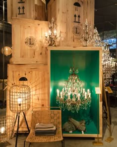 a chandelier is on display in front of wooden crates