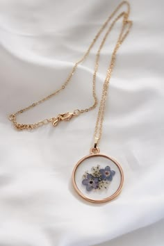 Forget-Me-Not and Queen Anne's Lace Pressed Real Wildflower Resin Necklace Click here for listing with an initial charm: https://www.etsy.com/listing/1280213974/personalizable-forget-me-not-and-queen?click_key=510eddfed650dbcbe98551aec3a27f1ee0bdf4e3%3A1280213974&click_sum=33b3a0ef&ref=shop_home_active_5&sts=1 Need your order ASAP? Choose "Rush My Order" to jump the line and get your order shipped same day or next! https://www.etsy.com/listing/1225937049/rush-my-order-add-on-1-day-processing?transaction_id=2997955938 Real wildflowers frozen in time. Flowers that will never lose their bloom.  This item is handmade (with love!) using REAL dried wildflowers and is set in clear resin. Each wildflower is unique and your necklace will be a true one-of-a-kind piece. Please note that small bubbles Necklace With Flowers Inside, Wildflower Resin, Dried Wildflowers, Easy Crafts To Sell, Pressed Flower Jewelry, Pressed Flower Necklace, Necklace Resin, White Jewelry Box, Queen Anne's Lace