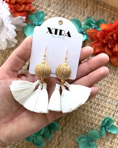 Materials Brass, 18k Gold Plated Fishhooks, Wood Beads, Raffia Tassels, Rattan Beads Dimensions Drop length: 3.5 Inches; Width: 2.0 Inches If you're looking for a bright white pair of statement earrings this summer, then these raffia tassel earrings are for you! They feature a large, beige, rattan bead accented with tiny wooden beads and bright white raffia tassels. They are lightweight and easy to wear all day long.These earrings drop approximately 3.5" inches from the lobe and measure about 2. Ceremonial White Earrings With Latkans, Elegant White Summer Tassel Earrings, White Drop Tassel Earrings For Beach, Handmade White Tassel Earrings For Beach, White Bohemian Tassel Earrings For Gift, Raffia Tassel, Flower Jewelry Designs, Earrings Drop, Fish Hook