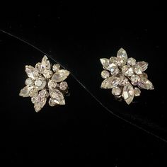 These glittery vintage silver tone and clear rhinestone clip on earrings were rescued from a lot of junk jewelry. They are set with a clear navette or marquise rhinestones with smaller round rhinestones. They are all prong set, with rivet and swedge construction. They are unsigned. An eye-catching pair of sparklers! Vintage Sparkling Earrings For Gift, Vintage Crystal Clip-on Earrings For Wedding, Silver Costume Jewelry Clip-on Earrings For Wedding, Vintage Crystal Earrings With Sparkling Stones For Gift, Silver Clip-on Cluster Earrings For Evening, Vintage Silver Crystal Earrings, Vintage Silver Clip-on Earrings With Rhinestones, Vintage Silver Earrings With Sparkling Stones, Vintage Crystal Earrings With Sparkling Details