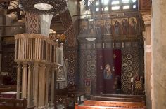 the interior of an old church with stained glass windows