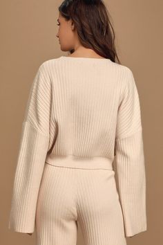 The Lulus Snuggly Style Cream Ribbed Knit Cropped Sweater is on the top of our must-have list! Cozy ribbed knit makes up this cute sweater with a rounded neckline, drop shoulders, and long wide sleeves that offer that perfect slouchy look. Relaxed-fit bodice ends in a cropped hem, perfect to wear with high-waisted bottoms. Pair with the matching pants for a complete look! Fit: This garment fits true to size. Length: Size medium measures 18.5" from shoulder to hem. Bust: Great for any cup size. Waist: Loosely Fitted. Undergarments: May be worn with any standard bra. Fabric: Fabric is very stretchy. Unlined. 55% Viscose, 28% Nylon, 17% Polyester. Hand Wash Cold. Do Not Bleach. Line Dry. Iron Low Heat. Imported. Lulus | Snuggly Style Cream Ribbed Knit Cropped Sweater | Size Small. Spring Cropped Knit Sweater With Ribbed Neckline, Knit Cropped Sweater With Ribbed Neckline For Spring, Casual Knit Cropped Sweater With Ribbed Neckline, Cable Knit Sweater For Loungewear, Chic Cropped Sweater With Ribbed Neckline For Winter, Beige Knit Top For Fall Loungewear, Chic Winter Cropped Sweater With Ribbed Neckline, Chic Ribbed Knit Cardigan, V-neck Ribbed Knit Top For Loungewear