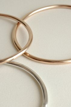 The Georgia is a timeless, minimalist bracelet style with an organic oval shape designed for constant wear. It is comfortable enough to wear even while sleeping, yet strong enough to gracefully withstand years of daily use. Each hand-soldered bracelet is shaped to mimic the contours of your forearm. Available in durable 14k gold fill, solid sterling silver, and solid 14k gold. These materials are water resistant and low maintenance. For more information, visit our Metals Encyclopedia. ✦ SIZING ( Minimalist Rounded Jewelry With Shiny Finish, Modern Round Cuff Bracelet With Shiny Finish, Modern Shiny Round Cuff Bracelet, Modern Rose Gold Bangle For Everyday, Modern Rose Gold Bangle, Modern Rose Gold Round Bangle, Modern Hoop Bangle For Everyday Wear, Modern Hoop Bangle For Everyday, Modern Round Rose Gold Bracelets