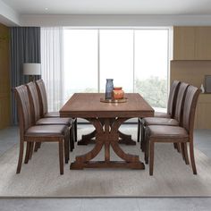 a dining room table with four chairs and a vase on the top of it in front of a large window