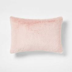 a pink pillow on a white surface with a light pink border around the edges and bottom