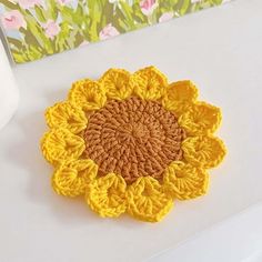 a crocheted sunflower sitting on top of a table