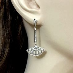 "Choose a pair of silver or rose gold cz linear bridal earrings in Gatsby Art Deco wedding style, featuring geometric fan shape dangles made of sparkly clear cubic zirconia with sterling silver posts in your choice of white, yellow and rose gold plating. Earrings are about 1 3/4\" (4.3cm) with posts. View matching pieces or similar designs at https://etsy.me/2UncS3p See all geometric designs at https://etsy.me/2eKf6s8 View all earrings at https://etsy.me/1f8VFT4" White Gold Cubic Zirconia Chandelier Earrings For Wedding, Diamond Drop Earrings For Wedding, Wedding Drop Diamond Earrings, Silver Diamond Clip-on Earrings For Wedding, Silver Art Deco Dangle Bridal Earrings, Art Deco Dangle Bridal Earrings For Anniversary, Art Deco Bridal Dangle Earrings For Anniversary, Silver Art Deco Bridal Earrings With Dangle Shape, Drop Earrings With Diamond Accents For Wedding