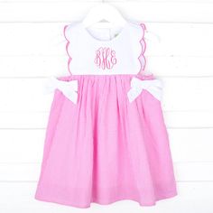 This Pink Gingham Scalloped Bib Dress is a stylish and comfortable outfit perfect for any sunny day. The sleeveless dress in pink gingham features a scalloped hem and white side tie bows. Personalize it by adding a monogram! Bib Dress, Comfortable Outfit, A Monogram, Pink Gingham, Toddler Clothes, Scalloped Hem, First Baby, Future Baby, Sunny Day