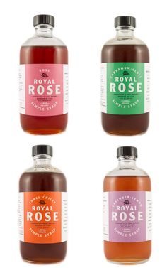 four bottles of royal rose syrup on a white background