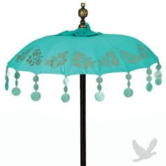 an umbrella with tassels hanging from it's sides and beads on the handle