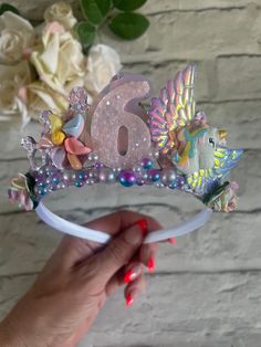 Birthday unicorn and rainbow crown. Made from pink glitter fabric, finished with an 1.5cm Alice band, suitable from the age of 3 years upwards. Crown is full of embellishments and mulberry flowers.  Safety Although all of my beautiful handmade accessories are made with great love and care, they do contain small parts. Children must be supervised whilst wearing bows or headbands and please remove their accessories when sleeping. Pink Crown-shaped Headband For Party, Adjustable Princess Crown For Party, Pink Crown Headband For Party, Pink Pinched Crown For Party, Adjustable Pink Crown With Round Shape, Pink Princess Crown For Party, Whimsical Adjustable Pink Crown, Princess Crown With Pinched Crown For Birthday, Princess Crown For Party With Pinched Style