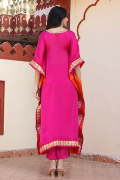 Magenta satin silk kaftan with placement floral gota work. Paired with a pant. Comes along with an inner - Aza Fashions Pink Silk Kaftan With Zari Work, Silk Palazzo Set With Embroidered Border For Festivals, Pink Embroidered Border Palazzo Set For Navratri, Navratri Pink Palazzo Set With Embroidered Border, Navratri Pink Embroidered Palazzo Set, Pink Embroidered Palazzo Set For Diwali, Pink Silk Floor-length Palazzo Set, Silk Kaftan With Zari Work For Reception, Pink Silk Kaftan For Festivals