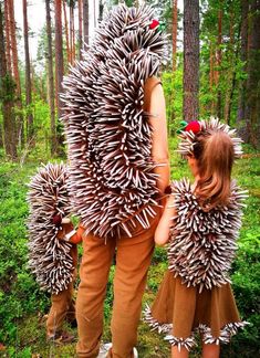 two children dressed in costumes made to look like they're walking through the woods