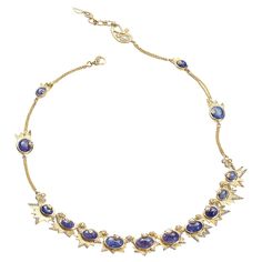 Sagrada Crescent Necklace Set in 20 karat Yellow Gold with 2.91-carat Diamonds and 27.20-carat Tanzanite. Luxury Oval Tanzanite Necklaces, Luxury Tanzanite Necklaces For Anniversary, Luxury Tanzanite Necklace For Anniversary, Fine Jewelry Tanzanite Necklace, Yellow Gold Tanzanite Oval Necklace, Luxury Tanzanite Gold Necklaces, Yellow Gold Tanzanite Necklace For Anniversary, Gold Tanzanite Necklace For Anniversary, Crescent Necklace