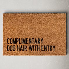 a door mat that says complimentry dog hair with entry