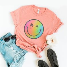 Looking for a cute versatile top to wear? Make sure to grab one of our Graphic tees! This soft and comfortable graphic tee is the perfect top for any outfit. It can be paired with biker shorts, jeans, or even a simple skirt/dress! This tee is true-to-size, so be sure to order your regular t-shirt size! If you are looking for a more oversized look, make sure to size up! Fun Crew Neck T-shirt For Loungewear, Cute Tops With Funny Print For Everyday, Fun Summer T-shirt For Everyday, Pink T-shirt With Funny Print For Everyday Wear, Funny Print Tops For Summer Loungewear, Trendy Crew Neck Top With Graphic Printing, Cute Everyday Tops With Screen Print, Cute Funny Print T-shirt For Everyday, Cute Screen Print Tops For Loungewear