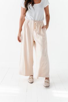 Features High Rise Wide Leg Side Pockets Zipper Closure Elastic waist with waist tie Lined from waist to thigh Cream color Self: 100% Polyester; Lining 100% Polyester Size + Fit Kristin is 5'4", a size 1 and is wearing a Small Jacquelyn is 5'4" and is wearing a size 25 Small 2-4, Medium 6-8, Large 10-12, X-Large 14-16 True to size. Do have stretch, but do not lose shape. Waist measurements are taken while laying flat and doubled. Click here for top Click here for shoes Size Waist Rise Inseam Sma Curvy Swim, Curvy Dress, Black Sand, Swim Bottoms, New Arrival Dress, Waist Tie, Skirt Pants, Sweater Jacket, Cream Color