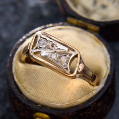 an antique diamond ring sits in its box