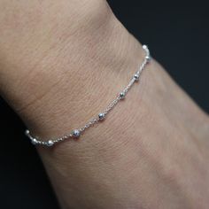 The elegant ball chain bracelet is crafted from fine sterling silver, featuring uniformly sized beads for a refined appearance. Its simple yet sophisticated design makes it perfect for both casual and formal occasions. The bracelet is finished with a secure lobster clasp for added durability. * Design: Anchor Bracelet * Material: High-quality 925 sterling silver for lasting shine. * Tarnish resistant + Hypoallergenic * Bracelet length: 16.5 cm+3.5 cm  * Chain thick: 1.2 mm, ball thick: 2mm * Com Elegant Sterling Silver Beaded Bracelet, Sterling Silver Beaded Bracelets In Silver, Sterling Silver Beaded Bracelets With Beaded Chain, Silver Beaded Sterling Silver Bracelets, Silver Beaded Chain Bracelets In Sterling Silver, Silver Dainty Beaded Bracelets, Silver Beaded Chain Bracelets For Everyday, Elegant Sterling Silver Ball Chain Bracelets, Elegant Sterling Silver Ball Chain Bracelet