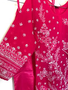 Latest in Chikankari,unique kurti with cape sleeves, surely a style statement!! Bright hot pink Kurti has fine resham thread hand embroidery and comes with a matching liner. Kurti length: 46 inches Festive Pink Straight Kurta Blouse, Pink Straight Kurta Top With Resham Embroidery, Pink Resham Embroidery Straight Kurta Top, Pink Kurta With Printed Motifs For Eid, Pink Printed Kurta For Eid, Traditional Dabka Tops, Pink Printed Blouse For Spring, Spring Pink Blouse With Printed Motifs, Pink Long Sleeve Kurta With Printed Motifs