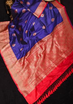 Tussar Silks have their own unique beauty and elegance! Their matt texture, variation in color absorption and rustic elegance make them a class apart! This saree comes in deep blue and is flanked by Red Borders with Zari work and meenakari buttas in two different colors! Zari detailing on the pallu and long tassels completes the look.  SILK MARK CERTIFIED This saree is ready to wear with fall and Pico done. Handmade silk tassels adorn the pallu and add more grace to it. An unstitched blouse fabr Silk Tassels, Tussar Silk Saree, Zari Work, Unique Beauty, Co Ord Set, Blouse Fabric, Rustic Elegance, Salwar Kameez, Silk Saree