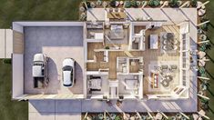 an aerial view of a house with two cars parked in the driveway