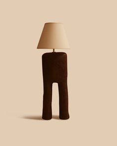 a lamp that is sitting on top of a wooden block in the shape of an elephant