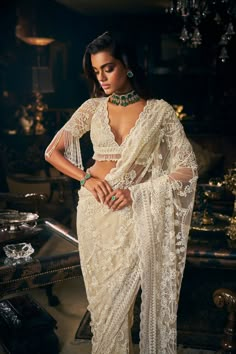 This ivory saree features all over three-dimensional embroidery. The blouse has a plunging neckline. The blouse sleeve hem shows pearl tassels. The saree comes with an optional veil.From Seema Gujral's Kashish collection DELIVERY TIMEPlease allow 8-12 weeks for your outfit to arrive. FABRIC DETAILSNet Professional cleaning only. Skirt Set Outfit, Pearl Tassels, Seema Gujral, Sabyasachi Sarees, Reception Saree, Sequin Saree, Floral Saree, New Saree Blouse Designs, Punjabi Outfits