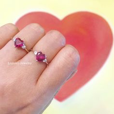 ♦ Handmade, high-quality item ♦ Material: 14K SOLID Rose Gold (can be made in Solid white/rose/yellow gold) ♦Finish: High Polishing Finish with Rhodium platting ♦ Center stone: Lab Created Ruby Heart ♦ Size/Weight: Heart 7*7mm / Approx 1.25 ct ♦ Side stones: Simulated Diamonds (CZ) ♦ Cut - Round 2.5mm ♦ Color Option: White Diamonds: D / Cognac Diamonds: C2 ♦Clarity: VVS1 ♦Cut Grade: Excellent ♦ Width of band bottom - 1.8 mm ♦ Thickness of the gold band - 1.2 mm 14k Gold Heart Cut Ruby Ring For Valentine's Day, Ruby Heart Ring For Valentine's Day, Valentine's Day Ruby Heart Ring In Fine Jewelry Style, Valentine's Day 14k Gold Heart Cut Ruby Ring, Valentine's Day Ruby Heart Ring Fine Jewelry, Fine Jewelry Ruby Heart Cut Promise Ring, Fine Jewelry Heart Cut Ruby Promise Ring, Fine Jewelry Ruby Heart Cut Ring For Promise, Ruby Ring With Diamonds For Valentine's Day Promise