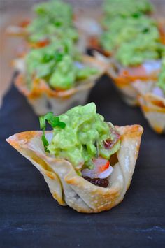 small appetizers with guacamole and other toppings