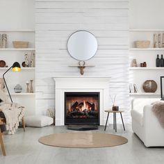 a living room with a fire place and white walls