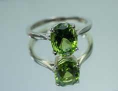 This is a beautiful Peridot from Pakistan set in Sterling Silver. This amazing stone has the perfect lime green color that many want with a great luster, and clarity!. Peridot is one of those underrated stones that has a quite remarkable history. Peridot is August's Birthstone. This nicely sized 9mm X 7mm Oval Peridot weighs 2.220cts and will go great with most styles or occasions. They will even go good with some of our Peridot Earrings located in our Gemstone Stud Earring Section. Please feel Green Peridot Jewelry With Prong Setting, Classic Peridot Jewelry With Prong Setting, Classic Peridot Jewelry For May Birthstone, Round Peridot Gemstones Fine Jewelry, Classic Peridot Solitaire Jewelry, Formal Peridot Gemstones For May Birthstone, Classic Green Gemstone With Center Stone, Classic Solitaire Peridot Jewelry, Lime Green Peridot Jewelry With Center Stone