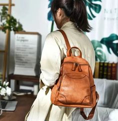 Step up your fashion game with this stylish ladies' backpack. Crafted from genuine leather, this waterproof backpack is both practical and fashionable. It features a soft handle strap for comfortable carrying and offers ample interior and exterior pockets, including a convenient silt pocket. Handmade with attention to detail, this vintage-inspired backpack is a must-have accessory for any fashion-forward woman.SpecificationsBrand Name: GeraldBlack Origin: Mainland ChinaCN: GuangdongMain Material: Genuine LeatherGenuine Leather Type: Cow LeatherLining Material: Organic CottonBackpacks Type: SoftbackInterior: Cell Phone PocketInterior: Interior Zipper PocketHandle/Strap Type: Soft HandleExterior: Silt PocketDecoration: NONEClosure Type: zipperTechnics: EmbossingCapacity: Below 20 LitreItem T Casual Leather Backpack For On-the-go, Trendy Leather Backpack With Large Capacity, Large Capacity Leather Backpack, Trendy Style, Large Capacity Trendy Leather Backpack, Trendy Soft Leather Backpack For On-the-go, Trendy Leather Backpack For Fall, Trendy Soft Leather Backpack For Everyday, Leather Backpack For Daily Use In Fall, Trendy Backpack With Leather Backing