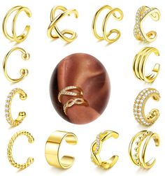 various types of gold rings and earring sets with diamonds on the sides, all in different shapes and sizes