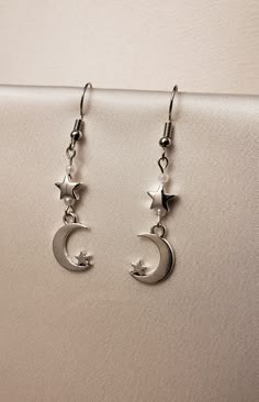 A set of earrings that feature moon and star charms along with small white pearls.  The hooks are made of nickel-free stainless steel. Star And Moon Earrings, Jewelry Accessories Ideas, Funky Jewelry, Drop Beads, Pearl Charms, Stainless Steel Earrings, Dream Jewelry, Stylish Jewelry, Star Charms