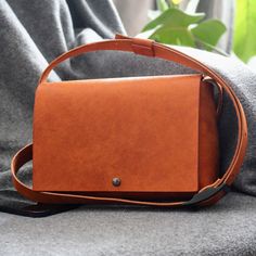 DESCRIPTION: Minimalist and stylish, this leather bag is made to last. The adjustable in length strap is 2.5 cm /1 in wide The leather we use for this bag and strap is 2.2 mm tick vegetable tanned leather. Everything is handstitched with 0.5 mm thick polyester waxed thread. The buckle is nickel tested, high quality and non harmful with 160kg breaking load. We use double rivet magnetic snaps for closing the bag. DIMENTIONS: Bag: 23 cm x 16 cm x 7 cm / 9" x 6.3" x 2.75" Strap width 2.5 cm / 1"  St Minimalist Rectangular Shoulder Bag With Adjustable Strap, Modern Crossbody Shoulder Bag With Leather Strap, Minimalist Brown Clutch Bag, Simple Solid Leather Shoulder Bag, Minimalist Clutch Shoulder Bag With Detachable Strap, Minimalist Crossbody Shoulder Bag With Adjustable Strap, Minimalist Soft Leather Clutch Shoulder Bag, Minimalist Bags With Detachable Strap, Minimalist Bags With Adjustable Strap