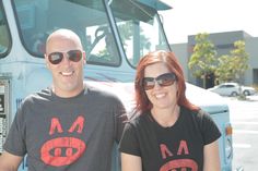 a man and woman standing in front of a truck