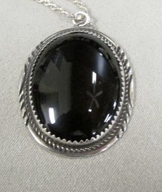 "Sterling silver and black onyx oval pendant. 1 3/8\" tall x 1 1/16\" wide. The 30\" sterling rope chain is included. The pendant is stamped H Sterling. There are some lines on the back of the pendant which appear to have been done on the inside under the stone. I don't know why. Otherwise good condition. PWC-2" Black Engraved Oval Pendant Jewelry, Classic Black Oval Pendant Jewelry, Black Oval Engraved Jewelry, Oval Black Engraved Jewelry, Black Oval Jewelry With Large Pendant, Black Round Pendant Necklace Collectible, Silver Oval Onyx Necklace, Silver Onyx Oval Necklace, Collectible Black Jewelry With Large Pendant