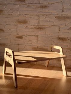 a wooden bench sitting on top of a hard wood floor