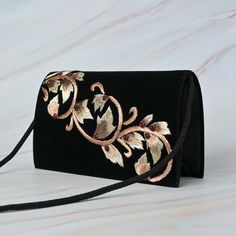 This beautifully stone studded Black Velvet Thread Work Handbag in velvet fabric fits for all occasions and attires. The handcrafted bag with intricate zardozi work and onyx stone makes it a best fit for all your formal and casual outings. The metal string makes it long lasting and the interior of this handbag is made with satin fabric and it has enough room to carry essentials and more.. This beautifully embroidered Clutch Purse is hand crafted using zardozi technique. Zardozi work is done carefully stitching layer upon layer of threads and metal wires and embellished with precious or semi precious gemstones making each piece one of its kind. Size cm : 20X12X05 Utility : Shoulder Bag Material: Velvet Fabric, Metal Thread Stones : Onyx Base Colours Available : Black Pockets: Single Care : Black Rectangular Velvet Bags, Black Velvet Rectangular Bags, Black Velvet Rectangular Bag, Elegant Black Velvet Bag, Elegant Black Velvet Bags, Formal Velvet Rectangular Shoulder Bag, Traditional Black Formal Bag, Formal Rectangular Velvet Bag, Formal Velvet Rectangular Bag