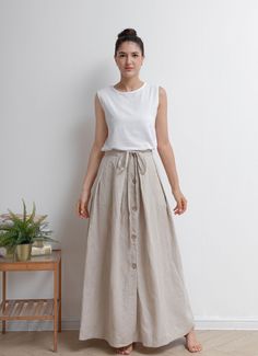 "Drawstring single breasted linen skirt made of natural linen fabric, front button closure, split hem, you can pair with everything you own in summer. ★★FEATURES 100% Linen Front button closure Waist with adjustable drawstring Front split skirt A Line skirt Casual skirt Perfect for Summer, Spring, Autumn ★★ Model Size Height approx 162 cm (5′ 4″) Bust 84 cm (33\") Waist 66 cm (26\") She wears size XS. ★★ Bespoke Order Service If you Request other color Request the length Your height is not betwe Lenin Skirt, Cottage Skirt, Linen Skirt Outfit, Cotton Skirt Outfit, Custom Skirt, Linen Skirts, Long Linen Skirt, Linen Style Fashion, Linen Maxi Skirt