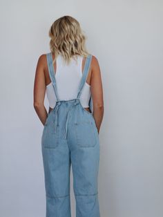 The "All American" overalls feature a straight neckline, front metal buttons, front side pockets, thick straps around the lower back, and ankle-length wide legs. True to size, little to no stretch Krista is wearing a Medium Krista's measurements: Waist- 27" Hips- 38" Height- 5'10" Bust- 34" (Typically a Medium) 100% COTTON Spring Medium Wash Overalls With Adjustable Straps, Casual Overalls With Tie Straps And Bib Front, Spring Overalls With Adjustable Straps, Medium Wash Shortalls With Adjustable Straps, Utility Jumpsuits And Rompers With Adjustable Straps For Spring, Trendy Denim Jumpsuits And Rompers With Adjustable Straps, Spring Medium Wash Overalls With Button Closure, Light Wash Overalls For Spring, Spring Denim Jumpsuits And Rompers With Adjustable Straps