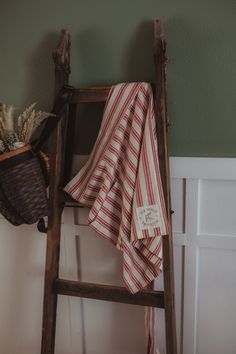 an old wooden ladder with a towel on it