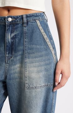 These baggy, high-waist jeans are designed with edgy rips, stitching detail and dramatic wide legs. 31" inseam; 22" leg opening; 13 1/2" front rise; 17" back rise (size 29) Zip fly with button closure 70% cotton, 30% Tencel® lyocell Tencel lyocell is a more-sustainably produced fiber made with closed-loop processing Machine wash, tumble dry Five-pocket style Imported High Rise Flare Jeans With Contrast Stitching For Spring, Denim Blue Flare Jeans With Contrast Stitching For Spring, High Waist Jeans With Contrast Stitching For Spring, Summer Denim Jeans With Contrast Stitching, Spring Flare Jeans With Contrast Stitching In Medium Wash, Distressed Wide Leg Cropped Jeans In Rigid Denim, Spring Cropped Denim Jeans With Contrast Stitching, High Waist Denim Cargo Jeans With Contrast Stitching, Distressed Wide Leg Cotton Cargo Jeans