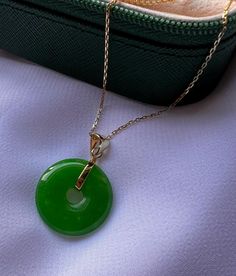 Embrace timeless elegance with this exquisite 14-carat gold-plated Jade round pendant necklace. The rich green  Jade gemstone is beautifully complemented by the luxurious gold plating, creating a piece that's both eye-catching and sophisticated. Perfect for any occasion, this necklace is designed to bring a touch of nature's beauty to your everyday wardrobe. Whether you're looking to elevate your own style or searching for the perfect gift, this necklace is a stunning choice. Crafted for durability and comfort, it's an affordable way to add a touch of luxury to your jewelry collection. Features: *14K gold-plated chain and setting for a luxurious look. * Jade gemstone with a classic round pendant design. *Versatile piece, ideal for layering or wearing alone.  *Perfect for gifting or treatin Luxury Oval Pendant Jade Necklace, Jade Gemstone Round Pendant Necklace, Gold Jade Round Pendant Necklace, Gold Jade Necklace With Round Pendant, Gold Jade Round Necklace, Elegant Jade Necklace Round Shape, Elegant Jade Round Necklace, Elegant Round Jade Necklace, Jade Jewelry With Round Stone For Gift